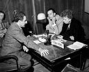1 April 1951 Seventh session of the Commission on Human Rights, United Nations, Geneva: Mrs. Eleanor Roosevelt, former Chairman of the Commission and delegate of the United States, discussing with the present Chairman, Mr. Charles Malik (Lebanon) (left); seating next to Mrs. Roosevelt is her son, Mr. Elliott Roosevelt.